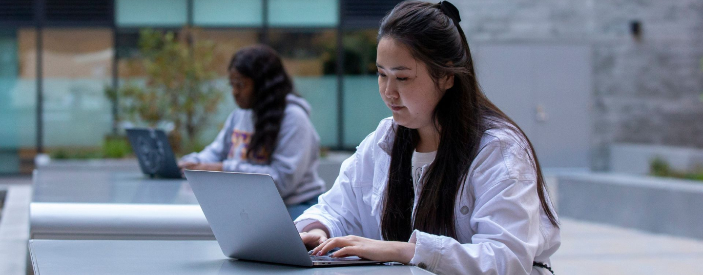 Student taking online course outdoors